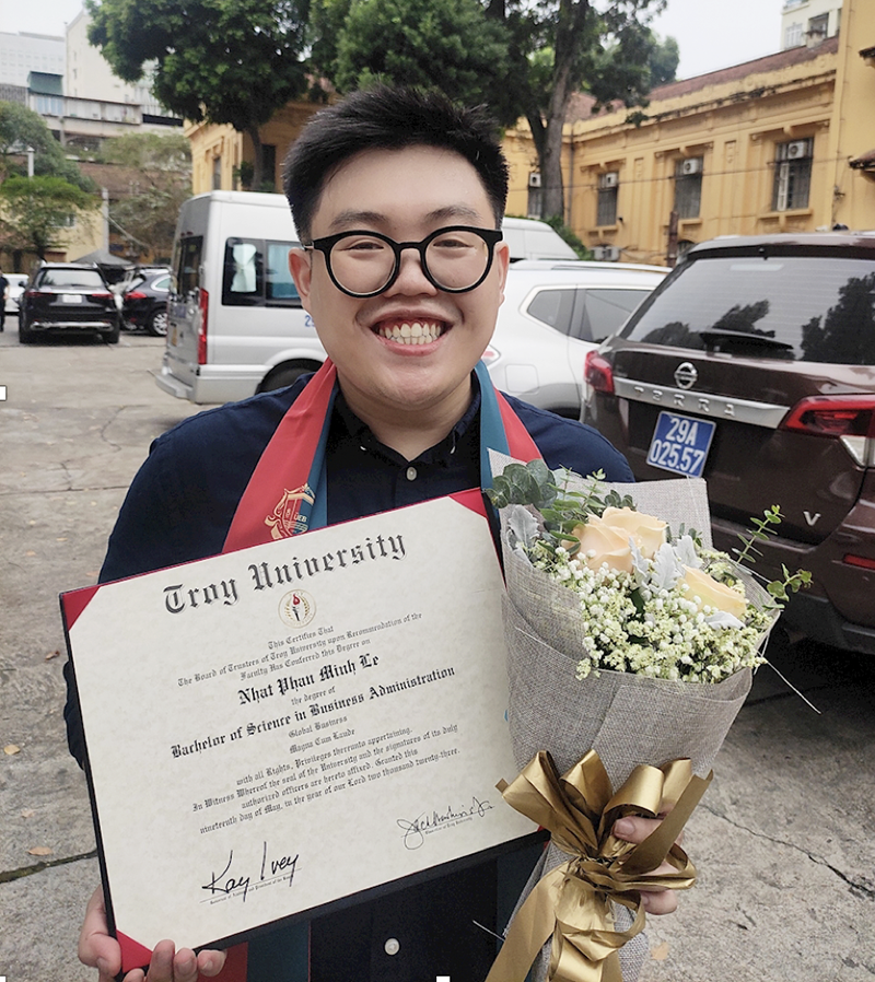 Le Phan Minh Nhat with his Troy University diploma
